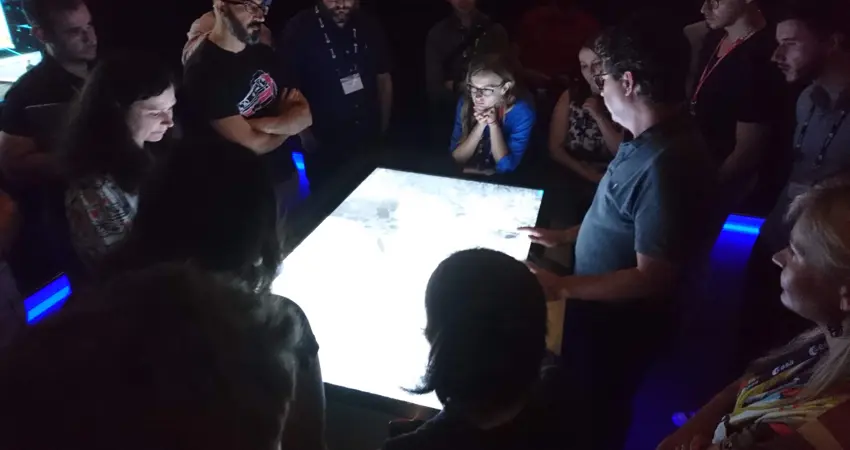 Frontier Development Lab team members looking at images on a lightbox