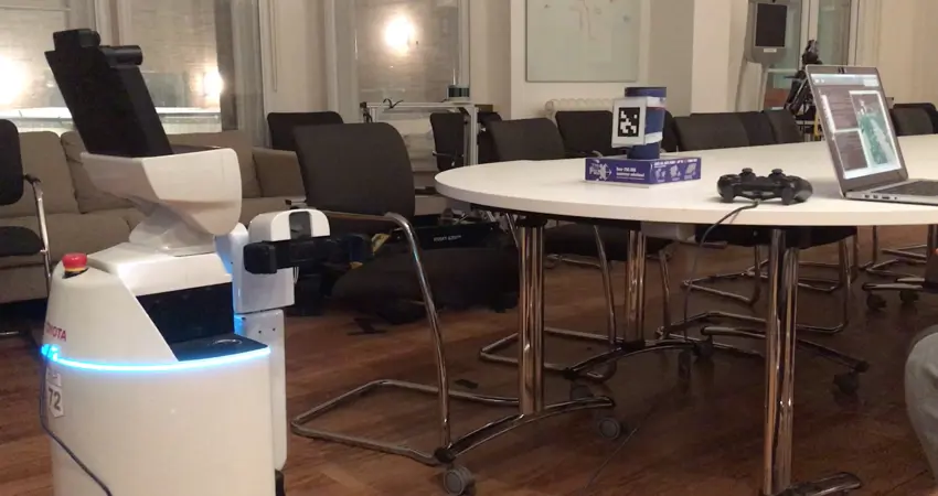 A robot in an empty conference room at Oxford's Department of Engineering Sciences